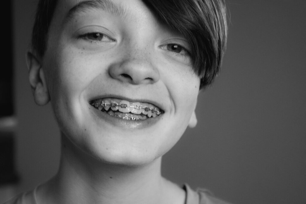 Smiling kid with braces, post-Halloween brushing tips from BCR Orthodontics in Winston-Salem
